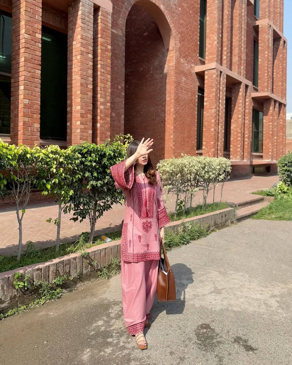 A Stylish Woman in Pink Pajamas Standing Gracefully