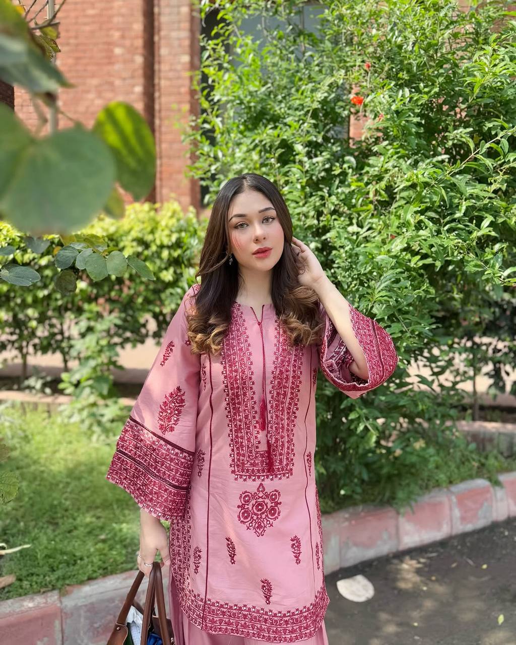 A Stylish Woman in Pink Pajamas Standing Gracefully