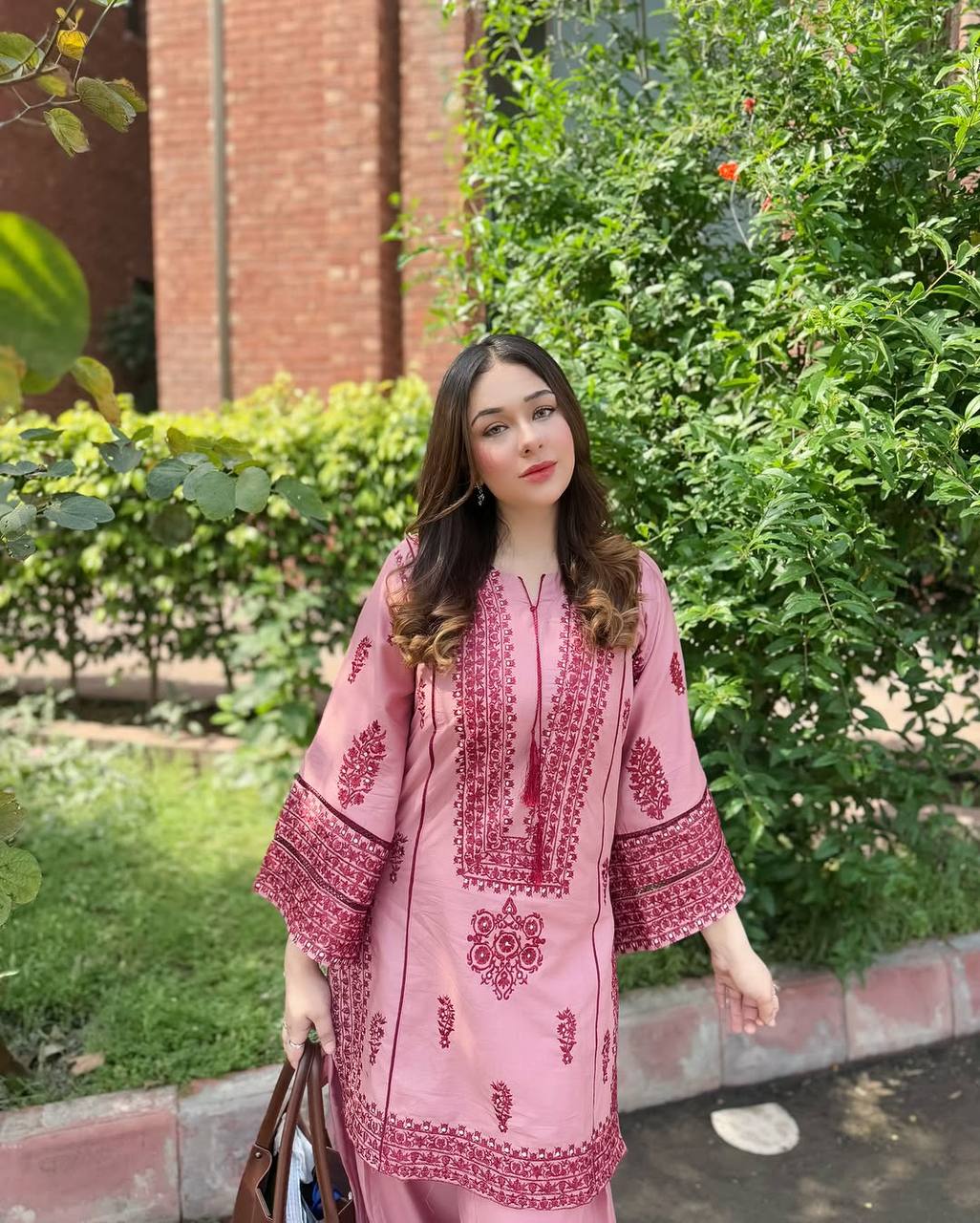 A Stylish Woman in Pink Pajamas Standing Gracefully