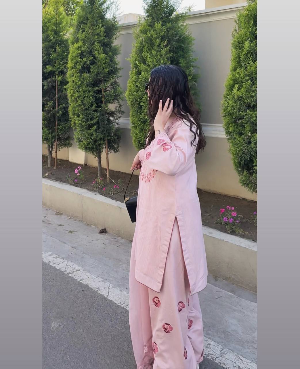 A Woman in Elegant Pink Attire Enjoying a Peaceful
