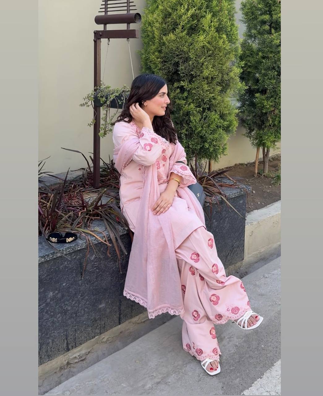 A Woman in Elegant Pink Attire Enjoying a Peaceful