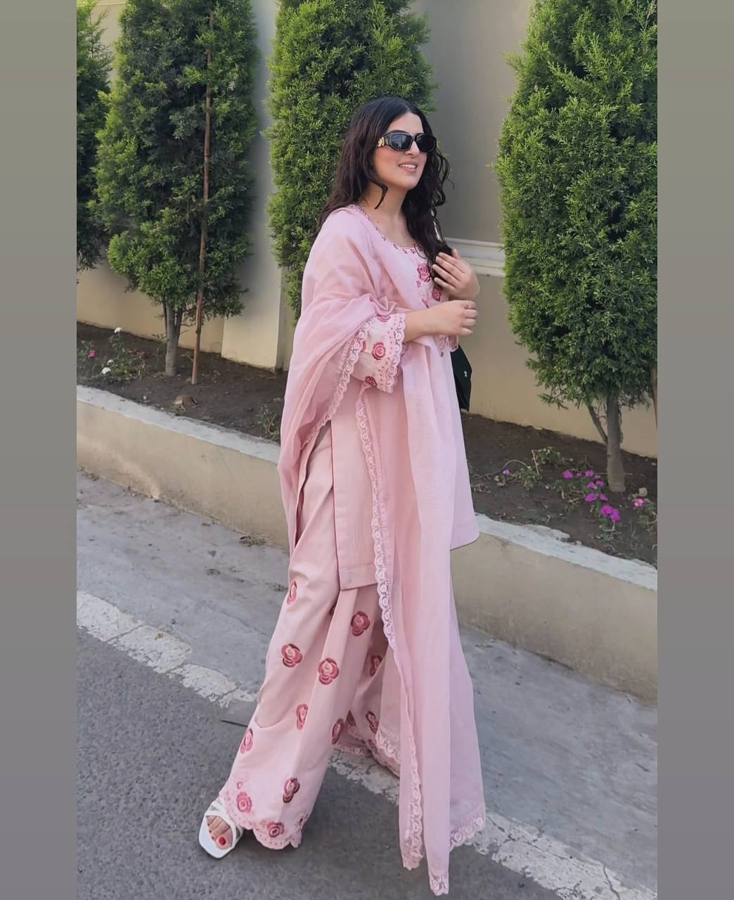 A Woman in Elegant Pink Attire Enjoying a Peaceful