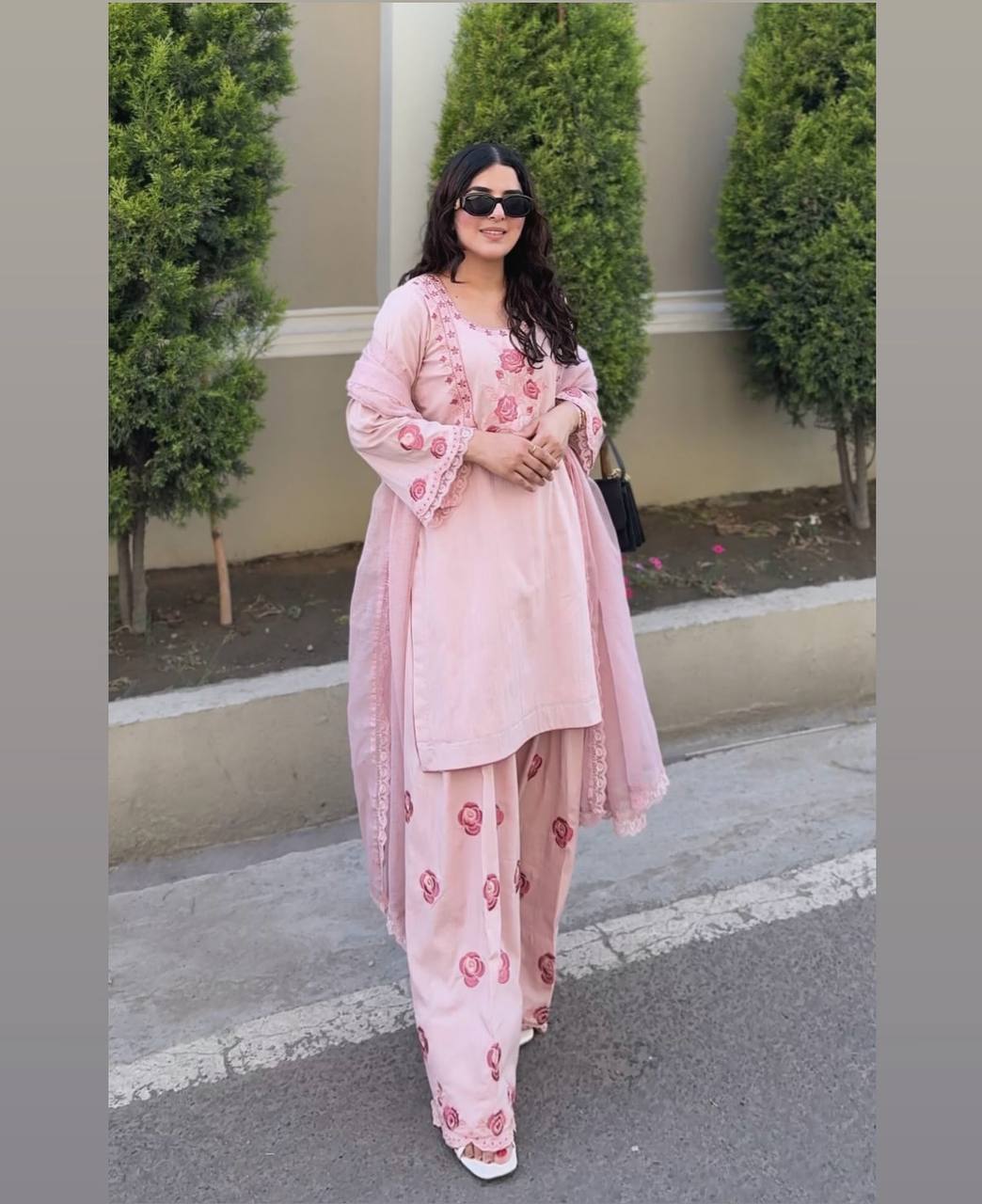A Woman in Elegant Pink Attire Enjoying a Peaceful
