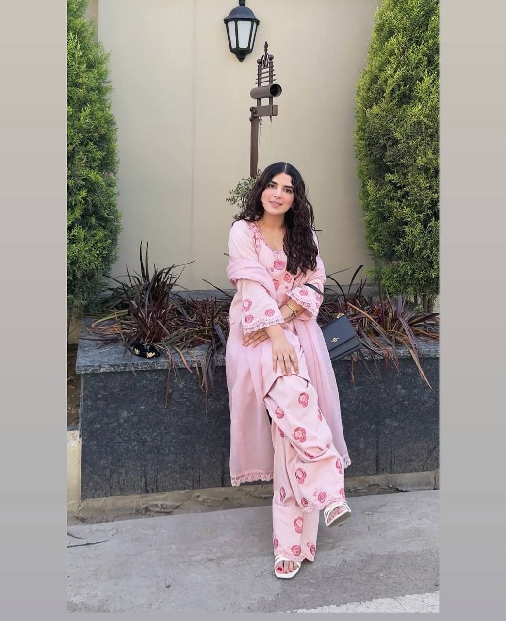 A Woman in Elegant Pink Attire Enjoying a Peaceful