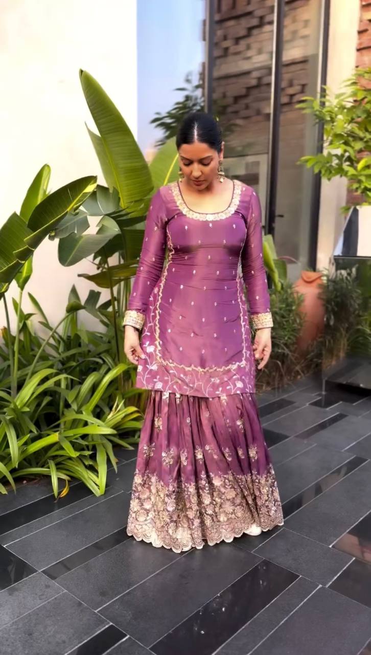 A Stylish Woman Adorned in a Pink Dress Standing Poised on a Charming Outdoor Patio