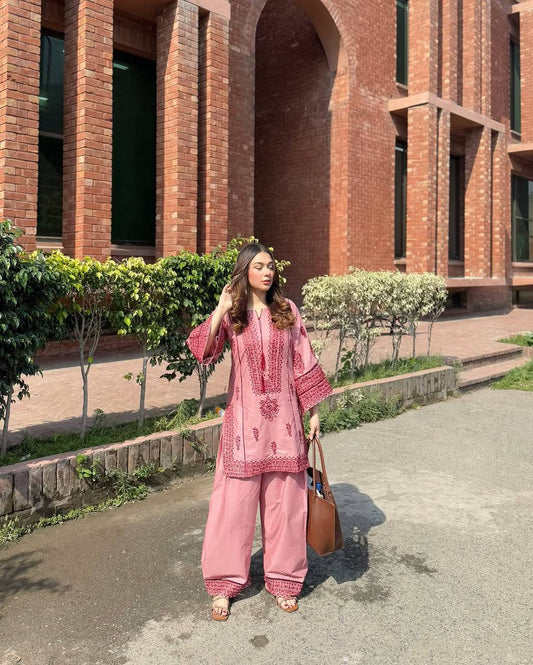 A Stylish Woman in Pink Pajamas Standing Gracefully