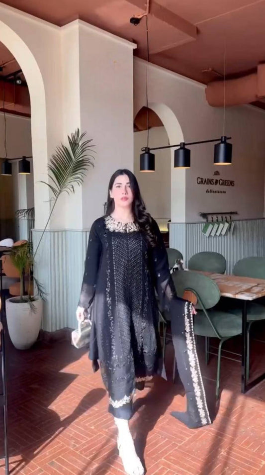 A Captivating Woman in a Black Dress Gracing the Ambiance