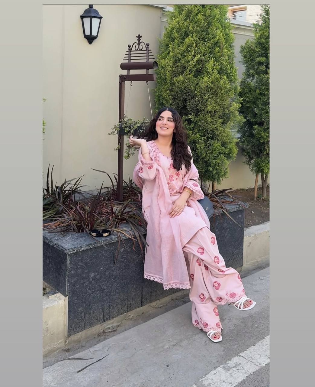 A Woman in Elegant Pink Attire Enjoying a Peaceful